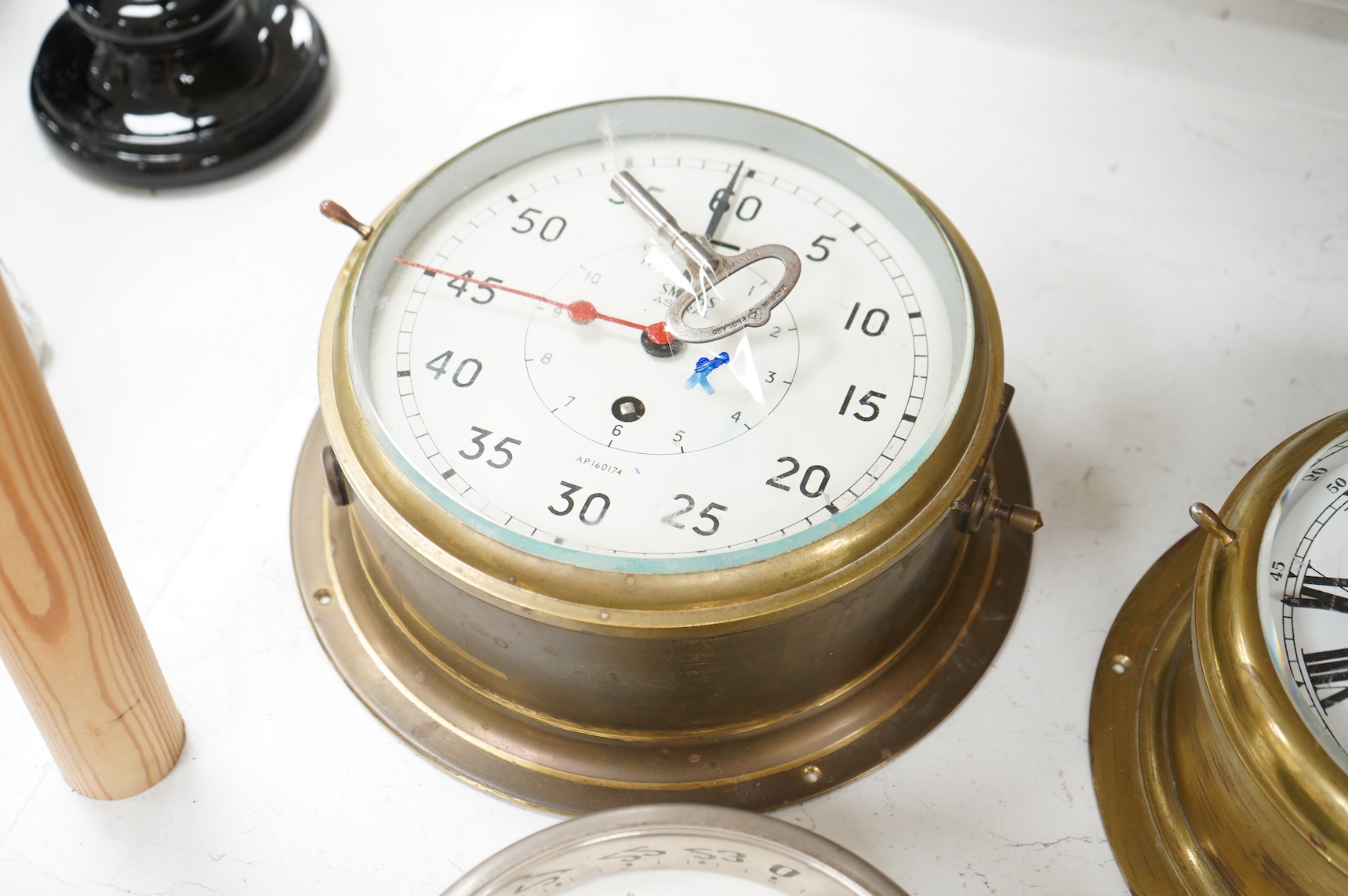 A ship's clock by Story of Barrow, a CCCP ship's clock and four other brass examples, some with keys, largest 28cm in diameter